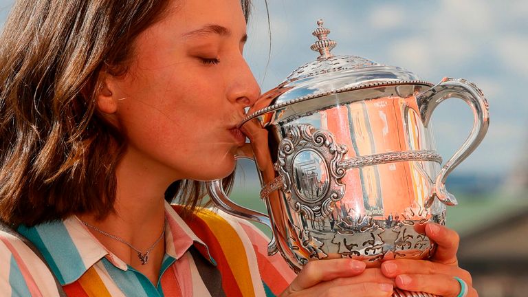 Poland's Iga Swiatek kisses the trophy Suzanne Lenglen as she poses near the Eiffel Tower in Paris, on October 11, 2020 a day after winning The Roland Garros 2020 French Open tennis tournament. 