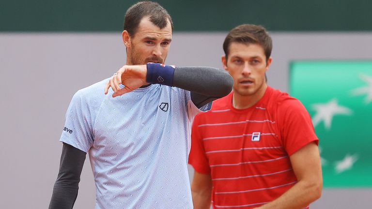Jamie Murray (L) and Neal Skupski of Great Britain talk tactics in their Men's Doubles first round match against Juan Ignacio Londerp or Argentina and Jiri Vesely of Czech Republic on day three of the 2020 French Open at Roland Garros on September 29, 2020 in Paris, France