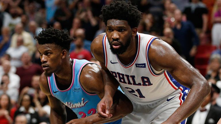 Jimmy Butler and Joel Embiid jostle for position during a Heat-76ers regular season game
