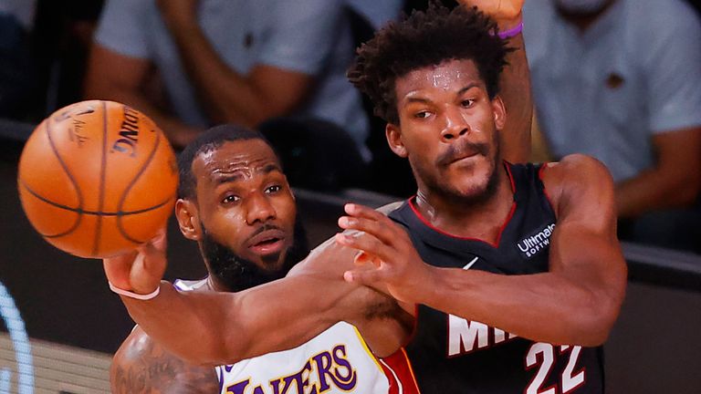Jimmy Butler, guarded by LeBron James, passes to a team-mate during Game 3 of the NBA Finals