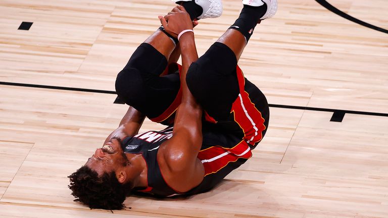 Jimmy Butler clutches his ankle during the Miami Heat's loss  to the Los Angeles Lakers in Game 1 of the NBA Finals.