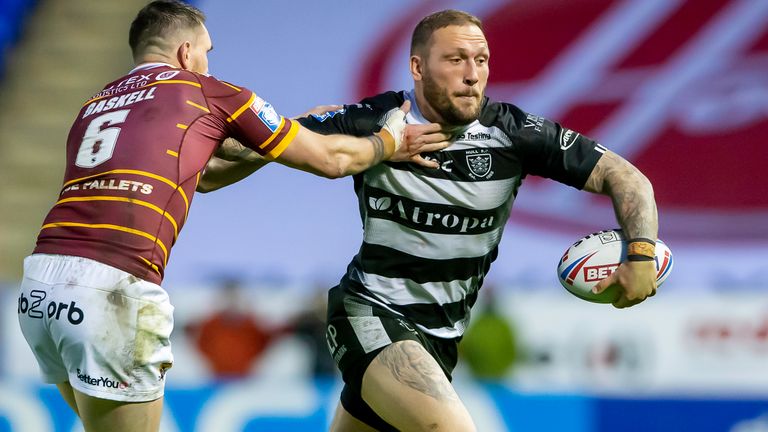 Hull FC's Josh Griffin fends off Huddersfield's Lee Gaskell