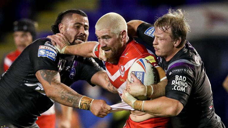 St Helens' Kyle Amor is tackled by David Fifita and Eddie Battye of Wakefield Trinity