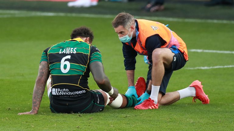 Courtney Lawes receives medical attention after injuring his ankle against Sale