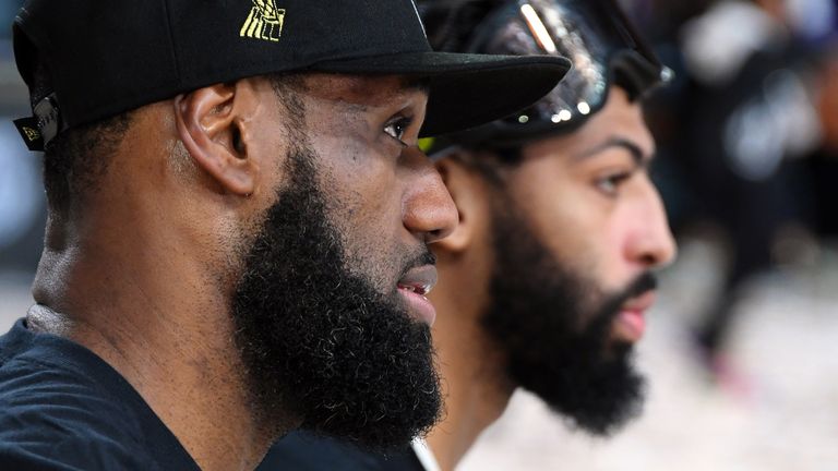 LeBron James and Anthony Davis pose for photographers after leading the Los Angeles Lakers to their 17th NBA championship