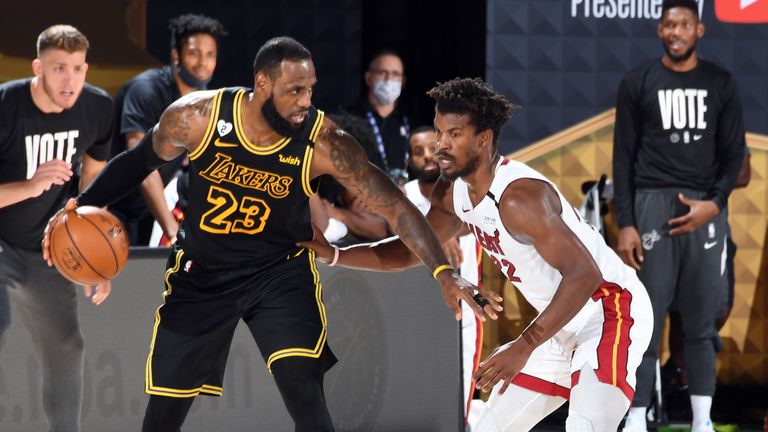 LeBron James of the Los Angeles Lakers handles the ball while Jimmy Butler of the Miami Heat plays defense during Game Five of the NBA Finals