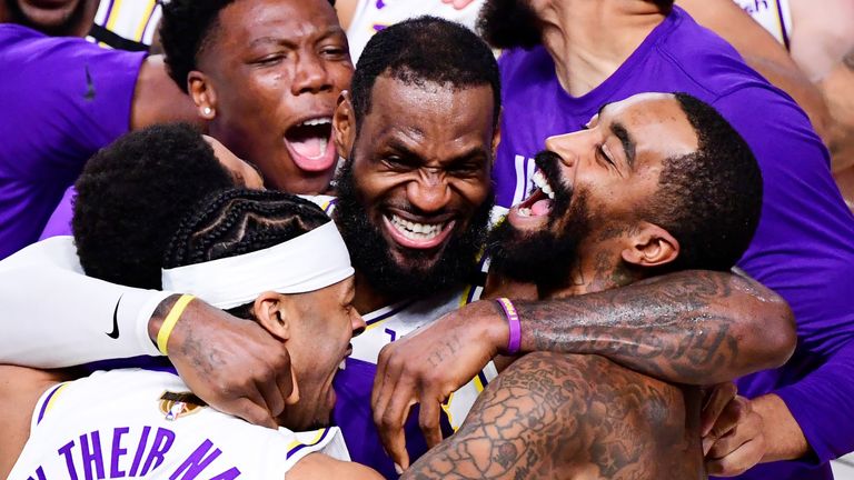 LeBron James is mobbed by his team-mates after leading the Los Angeles Lakers to the 2020 NBA championship
