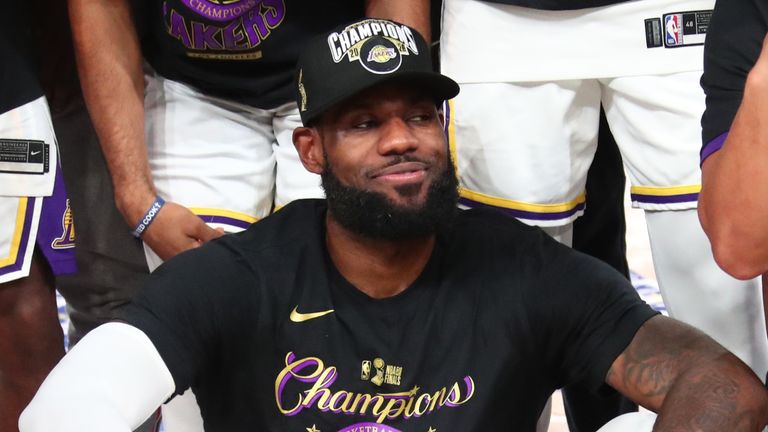 LeBron James poses with his NBA Finals MVP trophy after leading the Los Angeles Lakers to a 17th NBA championship