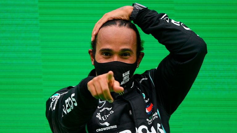 Mercedes' British driver Lewis Hamilton celebrates on the podium after winning the Portuguese Formula One Grand Prix at the Autodromo Internacional do Algarve on October 25, 2020 in Portimao.