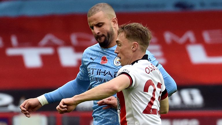 Manchester City's Kyle Walker (left) and Sheffield United's Ben Osborn battle for the ball