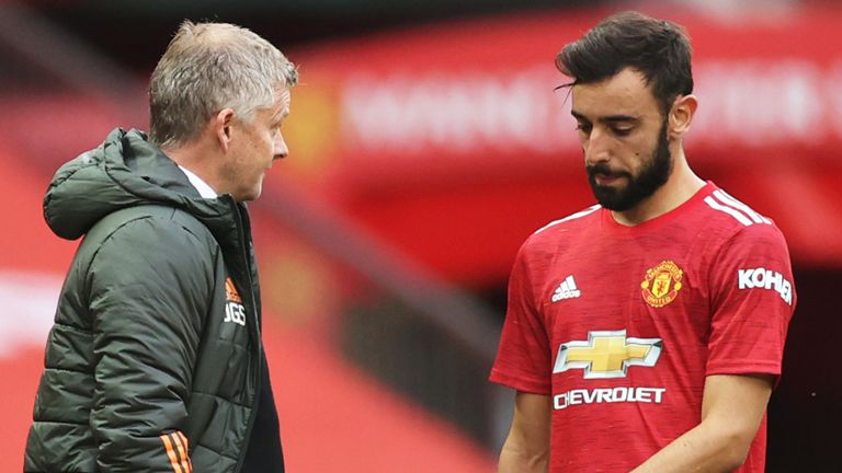 Ole Gunnar Solskjaer, Manager of Manchester United speaks with Bruno Fernandes of Manchester United during the Premier League match between Manchester United and Tottenham Hotspur at Old Trafford