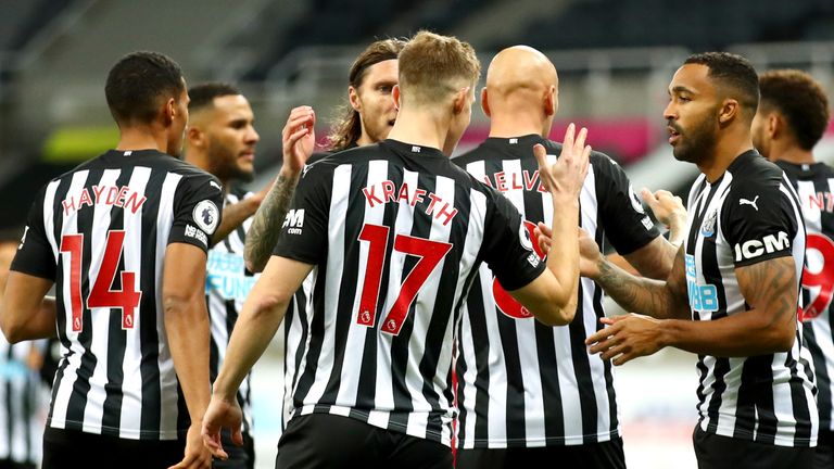 Newcastle players celebrate after taking the lead against Manchester United through Luke Shaw's own goal