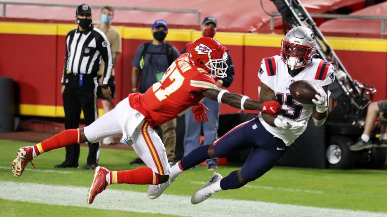 N&#39;Keal Harry #15 of the New England Patriots catches a touchdown pass ahead of Rashad Fenton #27 of the Kansas City Chiefs during the second half at Arrowhead Stadium on October 05, 2020 in Kansas City, Missouri. 