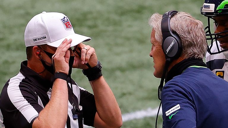 Seattle Seahawks head coach Pete Carroll converses with referee Shawn Hochuli during a game last month 