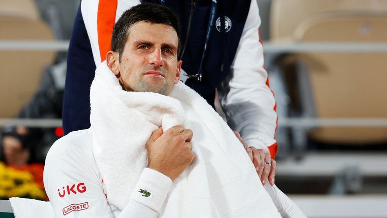 Novak Djokovic of Serbia receives medical treatment as he sits down in between games during his Men's Singles quarterfinals match against Pablo Carreno Busta of Spain on day eleven of the 2020 French Open at Roland Garros on October 07, 2020 in Paris, France