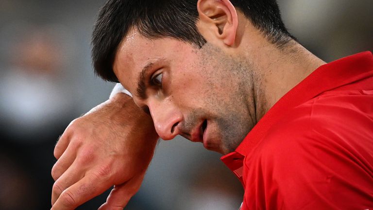 Serbia's Novak Djokovic reacts as he plays against Spain's Rafael Nadal during their men's final tennis match at the Philippe Chatrier court on Day 15 of The Roland Garros 2020 French Open tennis tournament in Paris on October 11, 2020.