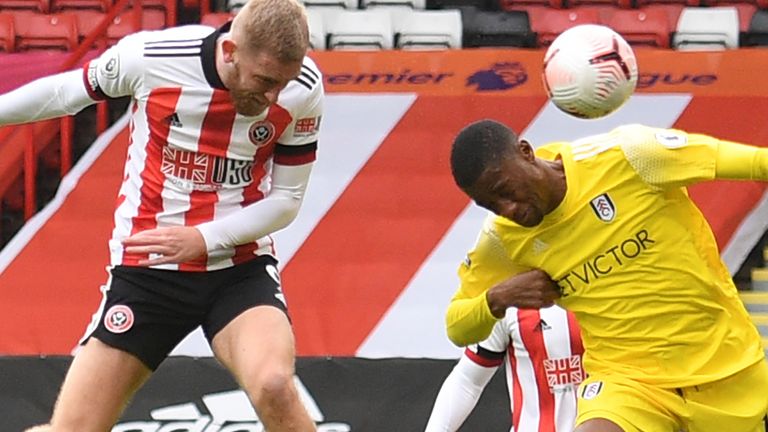Sheffield United striker Oli McBurnie (L) has this header saved by Fulham's French goalkeeper Alphonse Areola (not pictured)