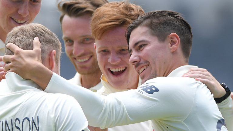 Ollie Pope and Rory Burns celebrate a wicket for England in 2020