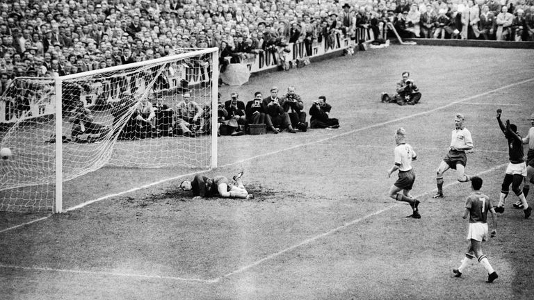 Brazilian soccer star Pele (right), waves his arms triumphantly after scoring his country's fifth goal in the World Cup Final against Sweden. The final score was 5-2 in Brazil's favor.