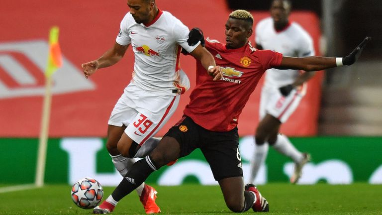 RB Leipzig's German defender Benjamin Henrichs (L) vies with Manchester United's French midfielder Paul Pogba during the UEFA Champions league group H football match between Manchester United and RB Leipzig at Old Trafford