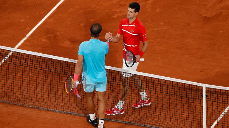 Rafael Nadal of Spain (L) embraces Novak Djokovic of Serbia at the net following victory in their Men's Singles Final on day fifteen of the 2020 French Open at Roland Garros on October 11, 2020 in Paris, France