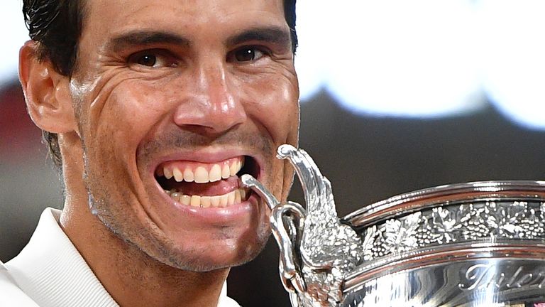 Spain's Rafael Nadal bites the Mousquetaires Cup (The Musketeers) as he celebrates during the podium ceremony after winning the men's singles final tennis match against Serbia's Novak Djokovic at the Philippe Chatrier court, on Day 15 of The Roland Garros 2020 French Open tennis tournament in Paris on October 11, 2020.