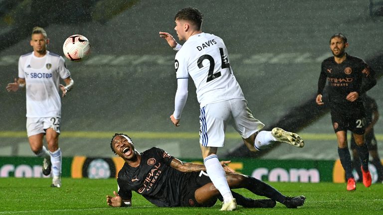 Raheem Sterling goes down late in the game under the challenge of Leif Davis