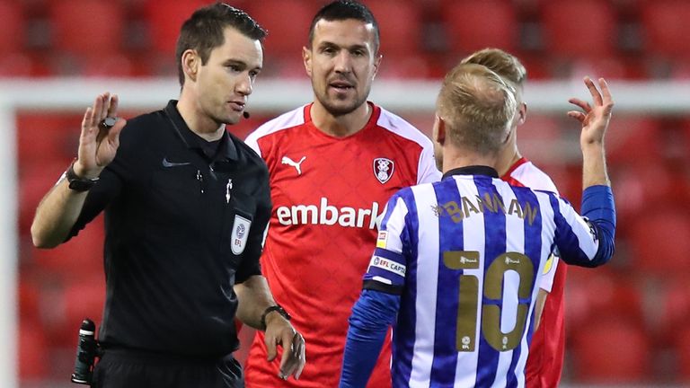 Referee Jarred Gillet informs both captains of the drone flying over the stadium and that they will need to be taken off the pitch during the Sky Bet Championship match between Rotherham United and Sheffield Wednesday