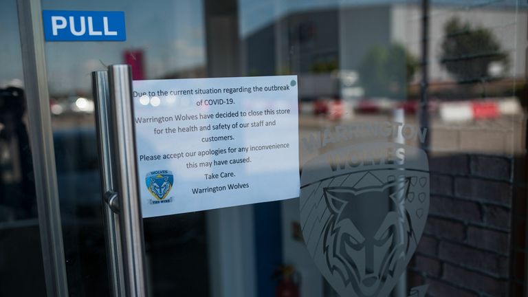 A notice on the door of the Warrington Wolves club shop in the Halliwell Jones Stadium, the home ground of the rugby league side Warrington Wolves, in Warrington, northern England on May 14, 2020. - Rugby league does not boast a global reach or the deep pockets of other sports as it attempts to navigate its way through the financially perilous coronavirus crisis.