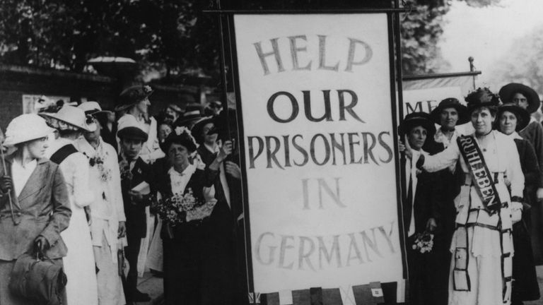 A crowd of female protestors in Britain, bearing a placard which reads 'Help Our Prisoners in Germany', circa 1914. They are protesting the internment of thousands of British civilians at Ruhleben (now a district of Berlin) at the start of World War I. (Photo by Central Press/Hulton Archive/Getty Images)