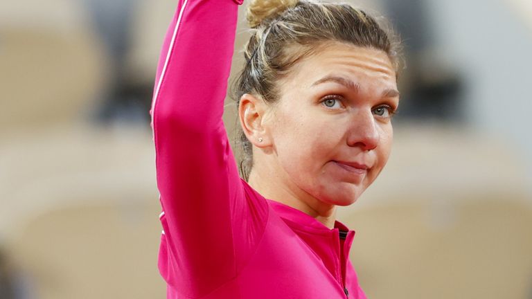 Romania's Simona Halep salutes the audience as she leaves the court after loosing against Poland's Iga Swiatek during their women's singles fourth round tennis match on Day 8 of The Roland Garros 2020 French Open tennis tournament in Paris on October 4, 2020.