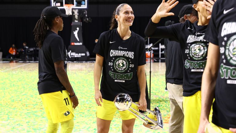 Sue Bird of the Seattle Storm holds on to the WNBA Championship trophy after defeating the Las Vegas Aces in the WNBA Finals