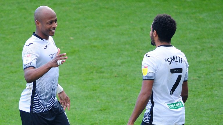 SWANSEA, WALES - OCTOBER 17: Andr.. Ayew of Swansea City celebrates scoring his side's first goal with team mate Korey Smith of Swansea City during the Sky Bet Championship match between Swansea City and Huddersfield Town at the Liberty Stadium on October 17, 2020 in Swansea, Wales. (Photo by Athena Pictures/Getty Images)