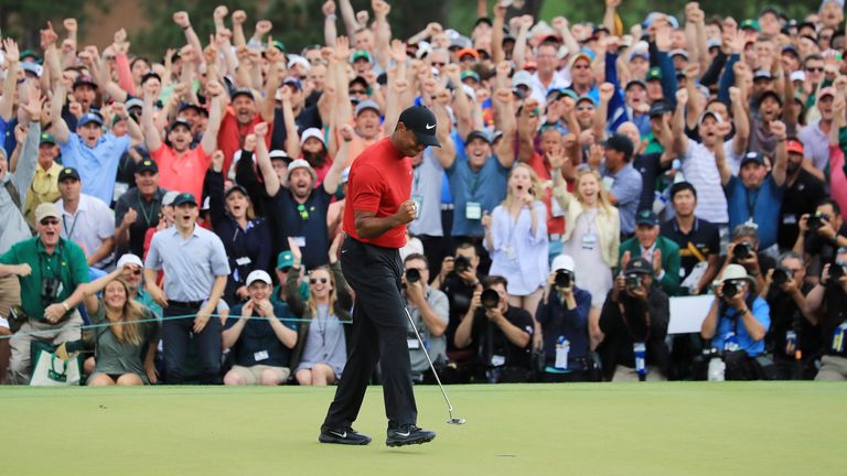 Tiger Woods celebrates his victory on the 18th green amid raucous celebrations from the patrons