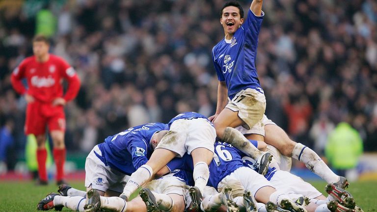 Tim Cahill celebrates as the Everton team pile on top of scorer Lee Carsley