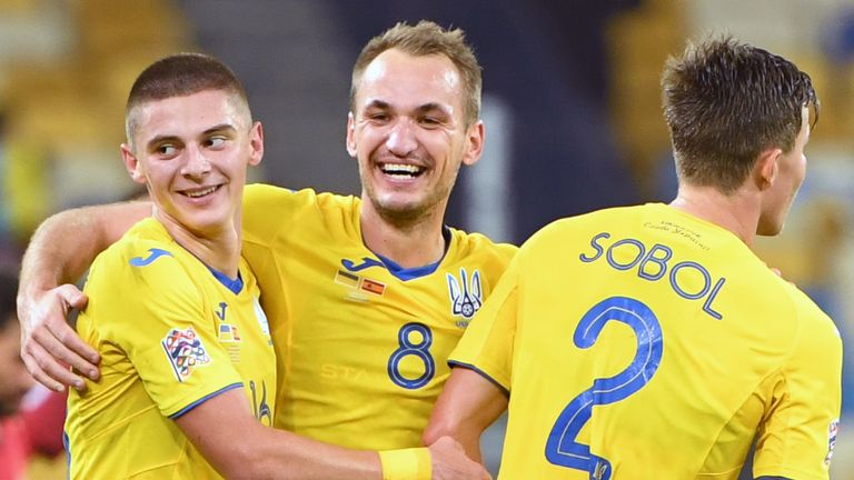 Ukraine's Vitaliy Mykolenko, Ukraine's midfielder Yevhen Makarenko and Ukraine's defender Eduard Sobol celebrate after the UEFA Nations League football match between Ukraine and Spain 