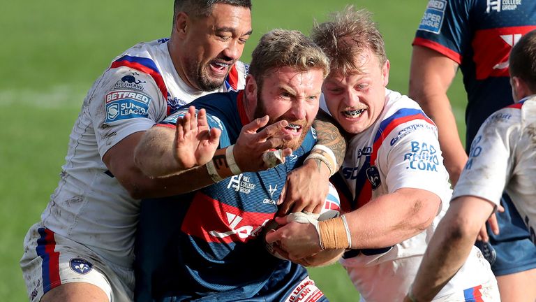 Will Maher is tackled by the Wakefield defence