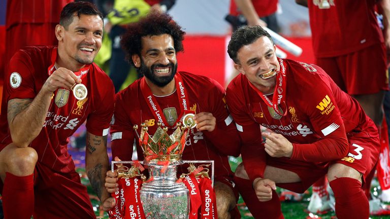 Dejan Lovren, Mohamed Salah and Xherdan Shaqiri of Liverpool celebrate with The Premier League trophy following the Premier League match between Liverpool FC and Chelsea FC at Anfield on July 22, 2020 in Liverpool, England. Football Stadiums around Europe remain empty due to the Coronavirus Pandemic as Government social distancing laws prohibit fans inside venues resulting in all fixtures being played behind closed doors