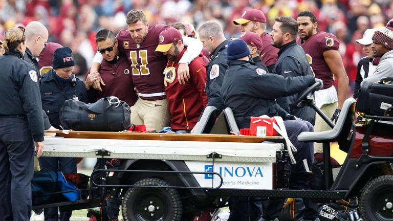 Alex Smith is helped off the field after his devastating leg injury