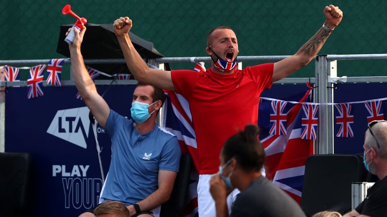 Andy Murray with the airhorn and Dan Evans cheer on Jamie Murray and Olivia Nicholls of Union Jacks as they compete in their doubles match against Cameron Norrie and Johanna Konta of British Bulldogs during day five of the St. James's Place Battle of The Brits Team Tennis at National Tennis Centre on July 31, 2020 in London, England.