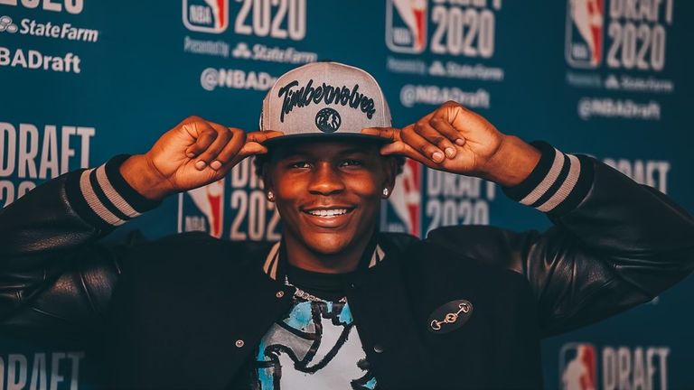 Edwards poses in his Timberwolves hat