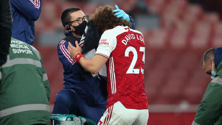 Arsenal's Brazilian defender David Luiz receives treatment after clashing heads with Wolverhampton Wanderers' Mexican striker Raul Jimenez during the English Premier League football match between Arsenal and Wolverhampton Wanderers at the Emirates Stadium in London on November 29, 2020