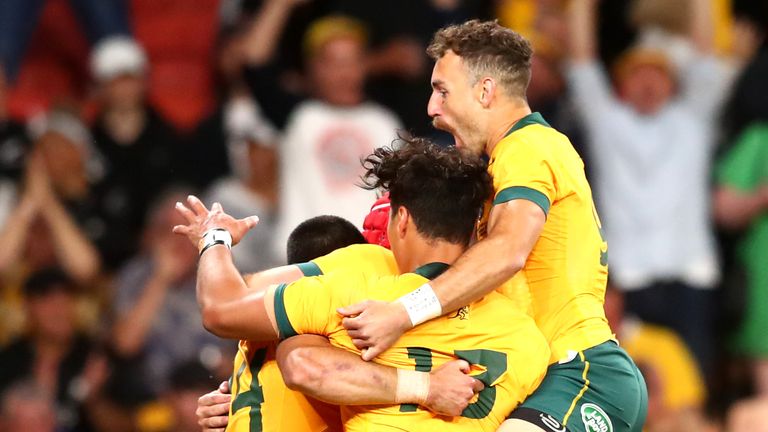 Australia celebrate scoring a try against the All Blacks