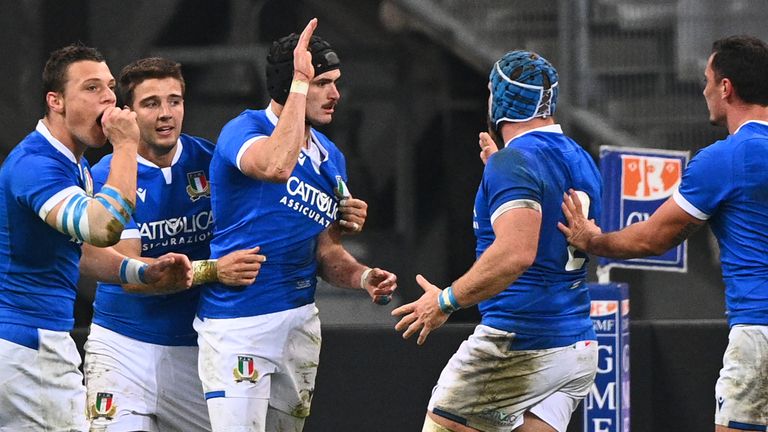 Italy's center Carlo Canna (C) celebrates with teammates after scoring a try during the Autumn Nations Cup Group B international rugby union match between France and Italy, at the Stade de France stadium, in Saint-Denis, on the outskirts of Paris, on November 28, 2020. (Photo by Anne-Christine POUJOULAT / AFP) (Photo by ANNE-CHRISTINE POUJOULAT/AFP via Getty Images)