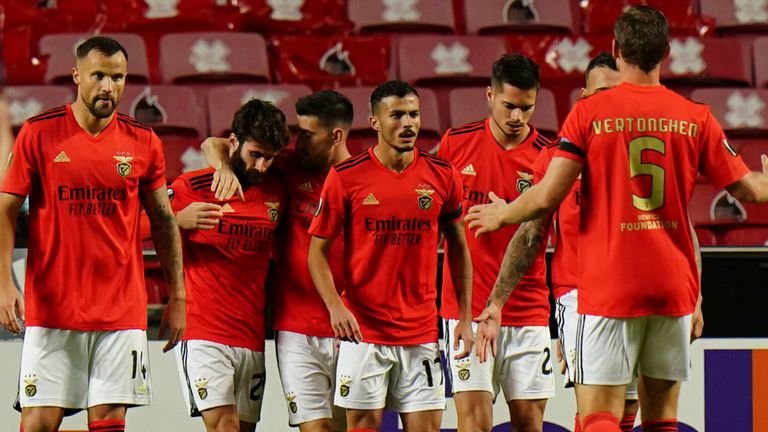 Benfica players celebrate after a Connor Goldson own goal makes it 1-0 vs Rangers