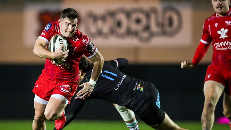 Scarlets' Dane Blacker makes a break to score a try.