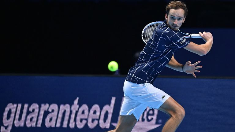 Russia's Daniil Medvedev returns to Serbia's Novak Djokovic during their men's singles round-robin match on day four of the ATP World Tour Finals tennis tournament at the O2 Arena in London on November 18, 2020. 