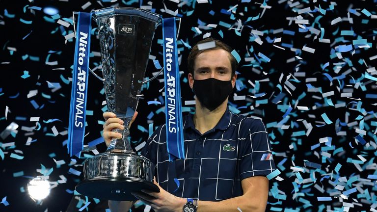 Daniil Medvedev poses with the winner's trophy after his 4-6, 7-6, 6-4 win over Austria's Dominic Thiem in their men's singles final match on day eight of the ATP World Tour Finals tennis tournament at the O2 Arena in London on November 22, 2020