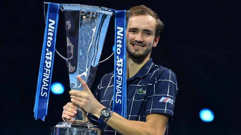 Russia's Daniil Medvedev poses with the winner's trophy after his 4-6, 7-6, 6-4 win over Austria's Dominic Thiem in their men's singles final match on day eight of the ATP World Tour Finals tennis tournament at the O2 Arena in London on November 22, 2020.