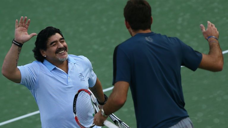 Argentina's football legend Diego Maradona (L) greets his compatriot tennis player Juan Martin Del Potro after a show following Del Potro's victory against India's Somdev Devvarman during the ATP Dubai Open tennis tournament in the Gulf emirate on February 27, 2013.